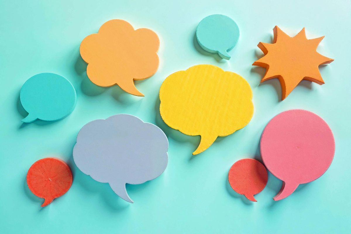 Colorful speech bubbles symbolizing conversation and communication, on a light blue background.